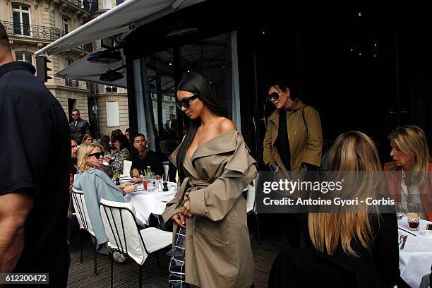 Kim Kardashian West and Kris Jenner leave 'L'Avenue' restaurant on October 2, 2016 in Paris, France.