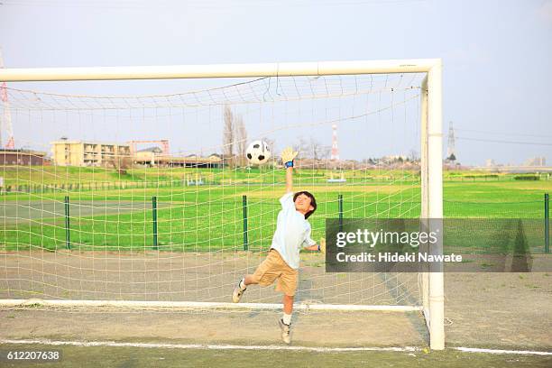 young boy goalkeeping on field. futako-tamagawa, setagaya-ku, tokyo prefecture, japan - japan football archive stock pictures, royalty-free photos & images