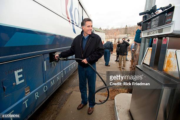 Republican presidential candidate and former MA Governor Mitt Romney pumping diesel into his campaign bus at Lowe's Store in Randolph, NH during a a...