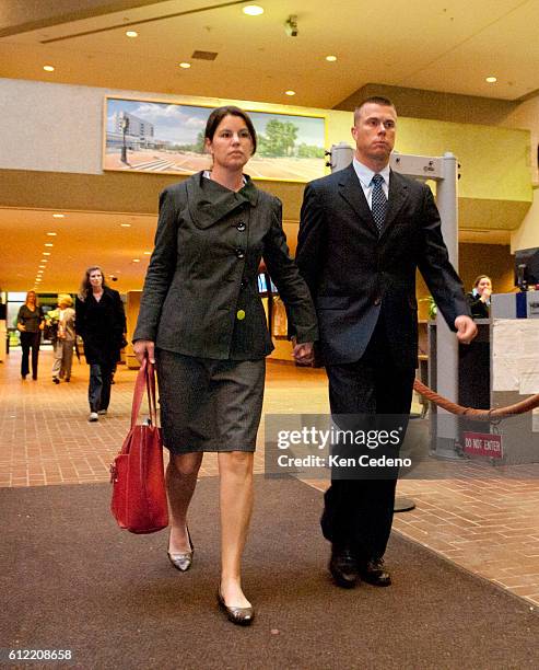 Kate McGrail-Murray, left, and husband Hugh Murray walk toward the exit of the Montgomery County Circuit Court in Rockville, MD October 27, 2011 on...