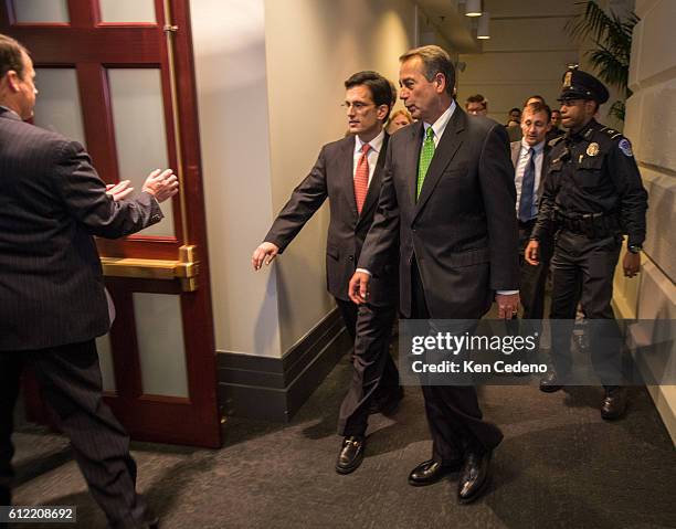 House Speaker John Boehner, center right, and House Majority Leader from Eric Cantor center left, walk into a Republican caucus meeting to consider...