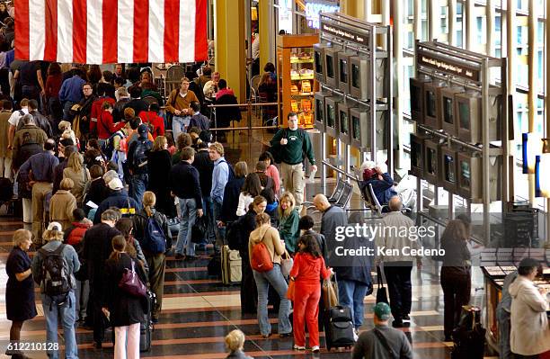 Travelers at Reagan National Airport in Arlington, Virginia, wait in long lines before having to pass through security. The day before Thanksgiving...