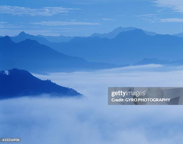 mountain peaks shrouded in mist, miyazaki prefecture, japan - miyazaki prefecture stock pictures, royalty-free photos & images