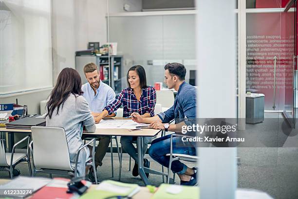 architects reviewing a blueprint at the office - industrial designer stock pictures, royalty-free photos & images