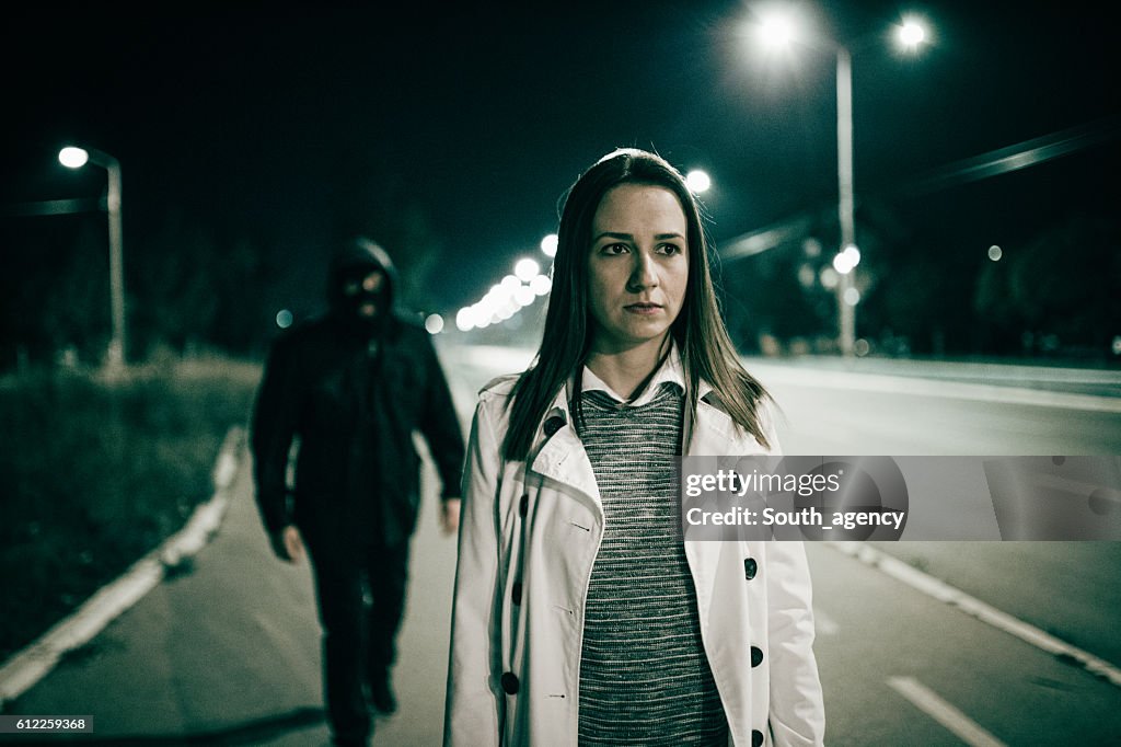 Robber walking behind a girl
