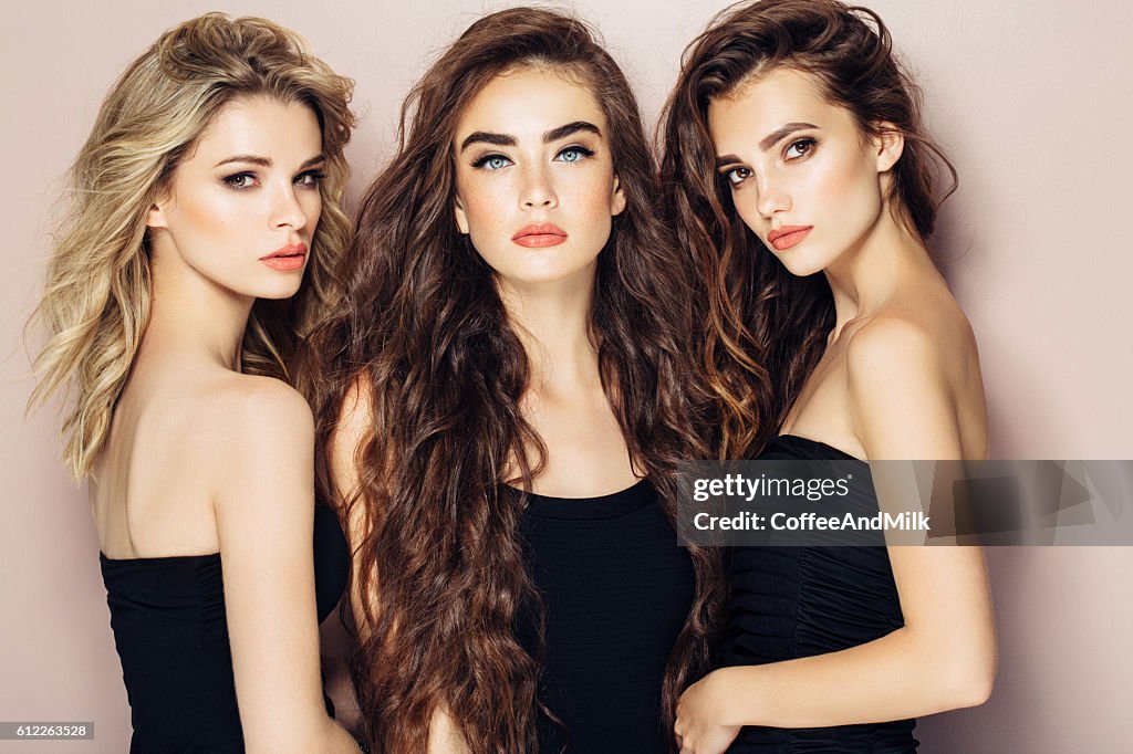 Three beautiful girls with perfect hairstyle and make-up