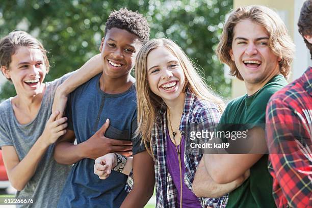 multiracial group of teenagers handing out outdoors - girl 18 stock pictures, royalty-free photos & images