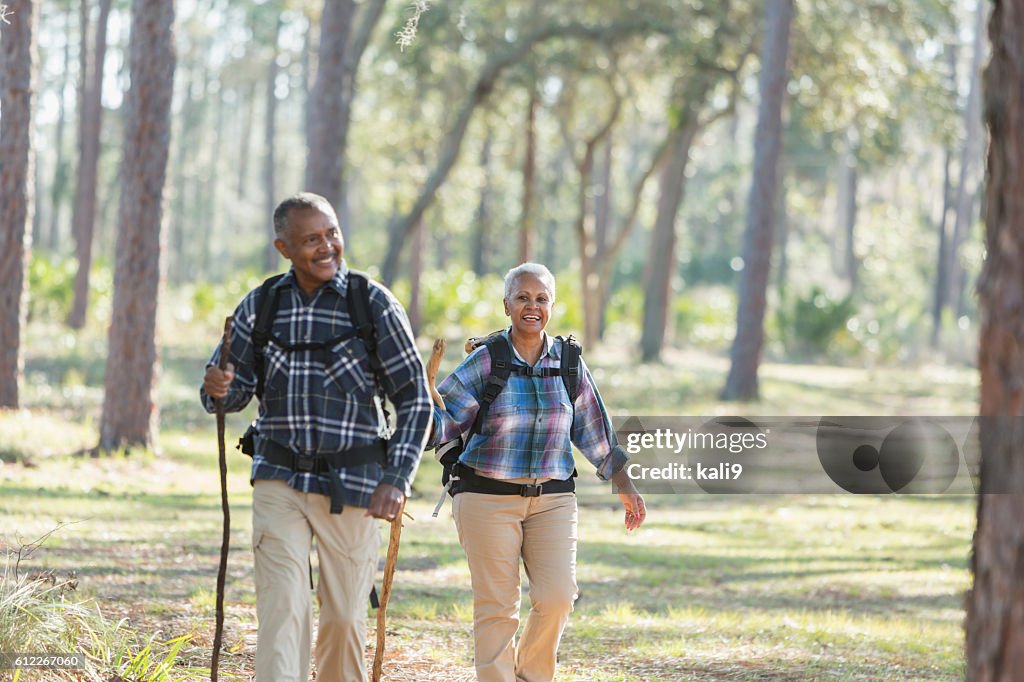 African American seniors hiking through woods