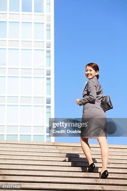 Businesswoman Walking Up Steps