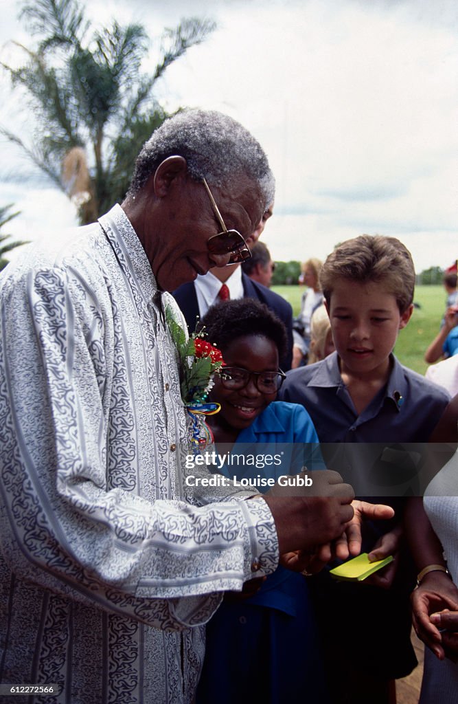 Nelson Mandela Signing Autographs for Youngsters