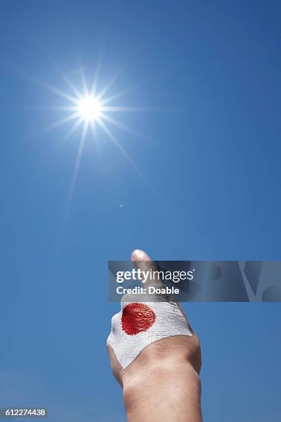 Hand Pointing at Sun, Japanese Flag Painted on Hand