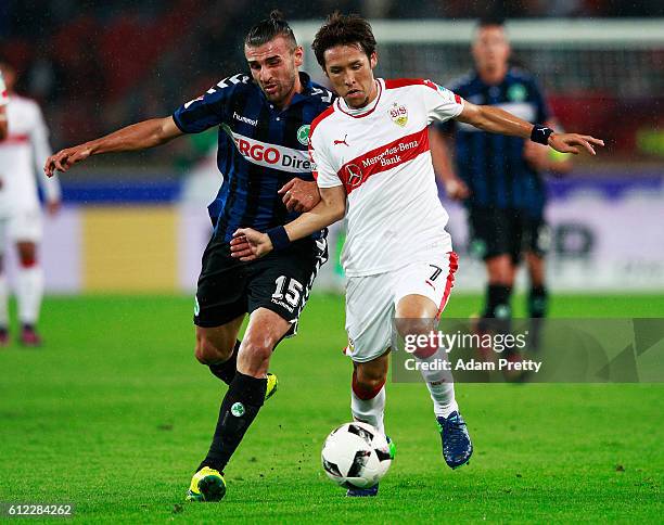 Hajime Hosogai of VfB Stuttgart is tackled by Serdar Dursun of SpVgg Greuther Fuerth before the Second Bundesliga match between VfB Stuttgart and...