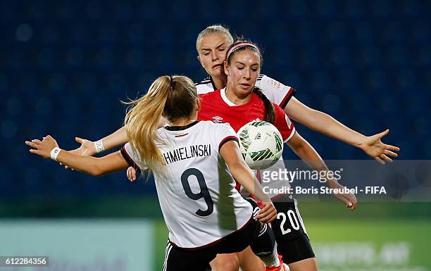 Gina Chmielinski and Lisa Schoeppl of Germany challenges Lauren Raimondo of Canada during the FIFA U-17 Women's World Cup Jordan Group B match...