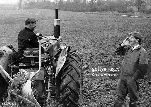 Agriculture. Farming Ploughing: 37 year old Mr. Giles Tedstone, manager of Doddington Park Farm, Nantwich, Cheshire shouts instructions to tractor...