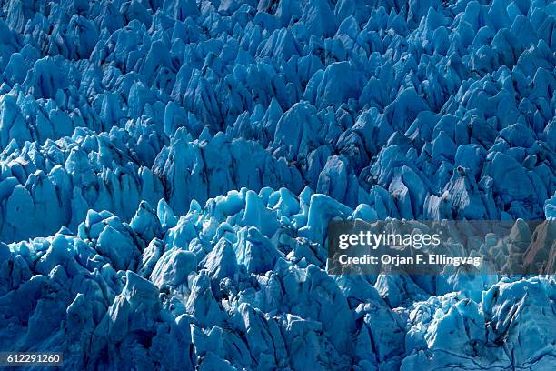 The Knik Glacier in Alaska. Lack of snow-cover expose the ash fallout from the nearby Redoubt Volcano, reducing the albedo effect. There are...