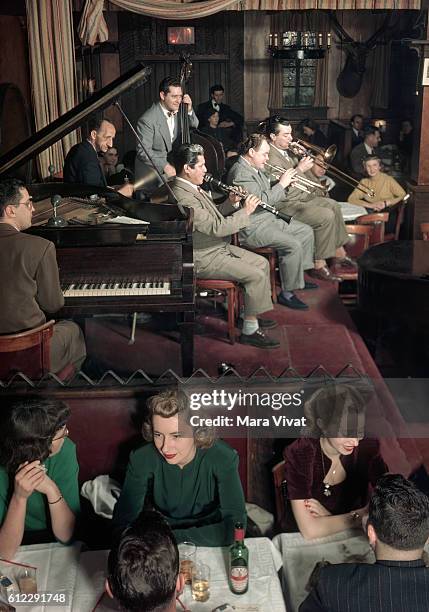 Diners enjoy the music of a jazz band at Dixieland Nicks in Greenwich Village, New York City. 1950. | Location: Dixieland Nicks, Greenwich Village,...