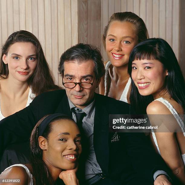 French actor Pierre Arditi surrounded by young women.