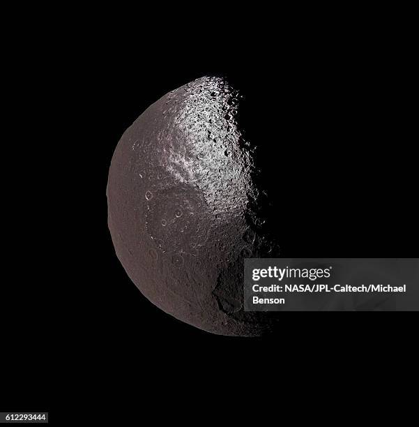 two-toned iapetus, saturn’s walnut-shaped moon - iapetus stock pictures, royalty-free photos & images