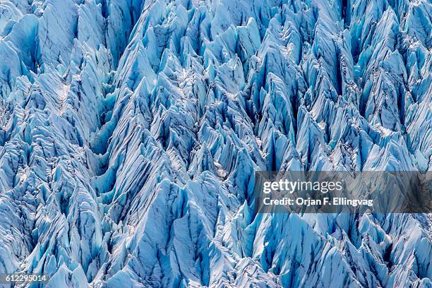 The Knik Glacier in Alaska. Lack of snow-cover expose the ash fallout from the nearby Redoubt Volcano, reducing the albedo effect. There are...