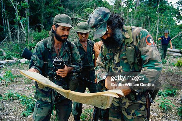 Anti-Sandinista rebels and Eden Pastora consult a map a the base camp along the San Juan river in southern Nicaragua. Eden Pastora was a famed...