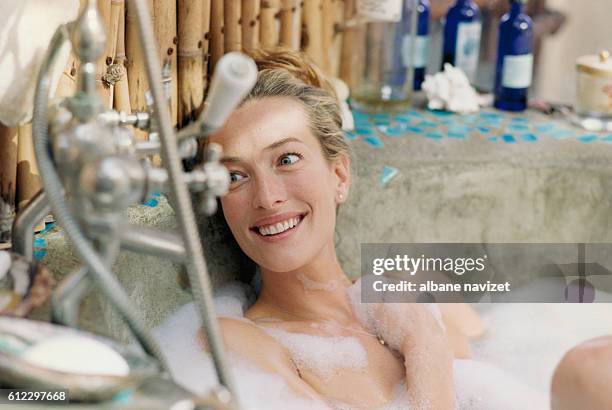 German model and actress Tatjana Patitz at home in the bath.