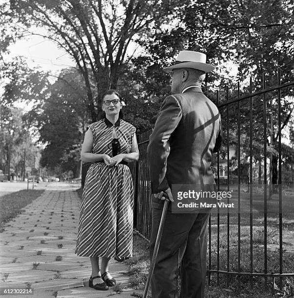 Former president Harry Truman talks to a woman on a stroll through a park. After his presidency ended in 1953, Truman retired to his hometown of...