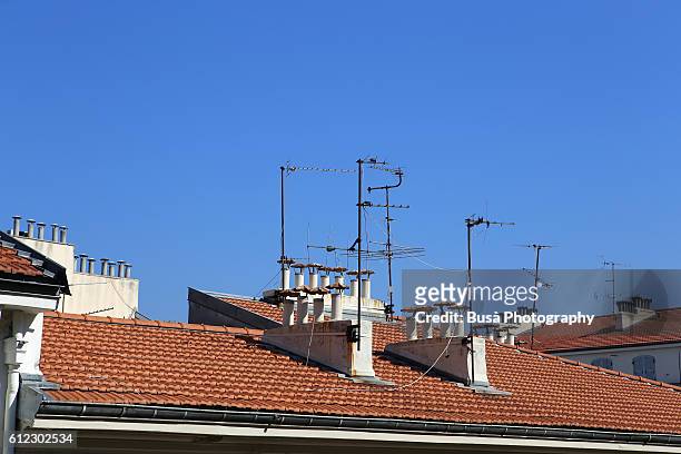 rooftops of old residential buildings in nice, france - television aerial stock pictures, royalty-free photos & images