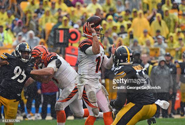 Quarterback Andy Dalton of the Cincinnati Bengals passes as he is pressured by linebackers Jarvis Jones and Arthur Moats of the Pittsburgh Steelers...