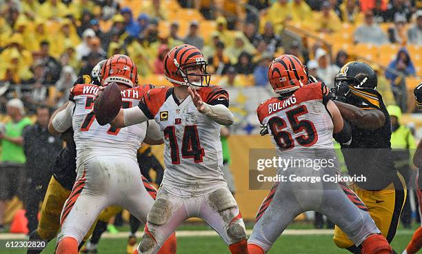 Quarterback Andy Dalton of the Cincinnati Bengals passes as offensive linemen Andrew Whitworth and Clint Boling block against the Pittsburgh Steelers...