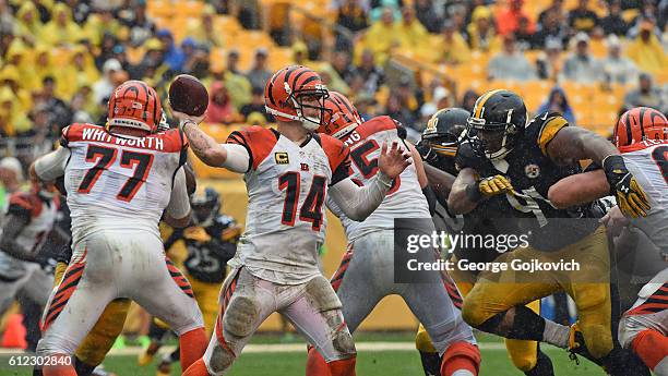 Quarterback Andy Dalton of the Cincinnati Bengals passes as offensive linemen Andrew Whitworth, Clint Boling and Kevin Zeitler block as defensive...