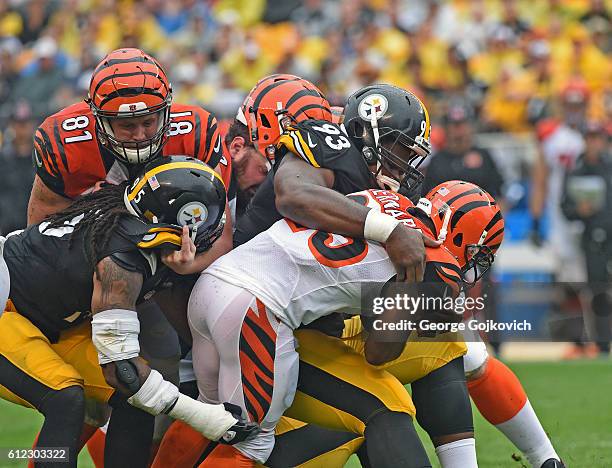 Defensive lineman Daniel McCullers and linebacker Jarvis Jones of the Pittsburgh Steelers tackle running back Giovani Bernard of the Cincinnati...