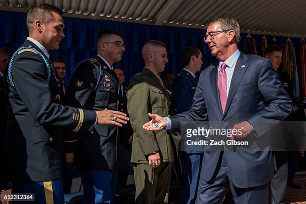 Defense Secretary Ash Carter hands out challenge coins during a ceremony honoring 2016 active duty military Olympians and Paralympians at The...