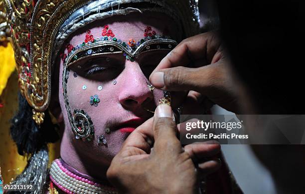 An Indian makeup artist prepare an artist as Seeta to take part in a religious procession known as 'Ram Barat' / Lord Ram's marriage ceremony during...