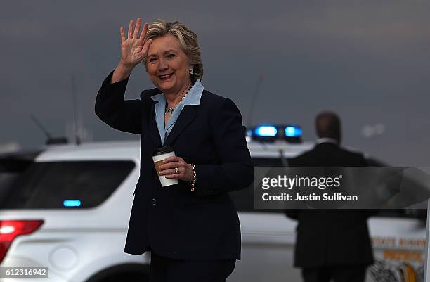Democratic presidential nominee former Secreatry of State Hillary Clinton waves as she arrives at Akron-Canton Airport on October 3, 2016 in North...
