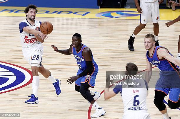 Victor Oladipo of the Oklahoma City Thunder is in action against Sergio Llull of Real Madrid during the basketball match between Oklahoma City...