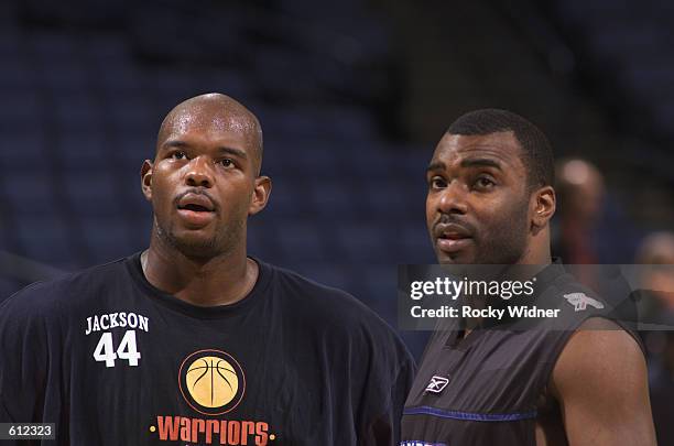 Marc Jackson of the Golden State Warriors talks to Aaron Mckie of the Philadelphia 76ers , before the NBA game at the Arena in Oakland in Oakland,...