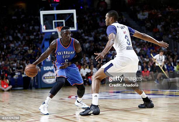 Victor Oladipo of the Oklahoma City Thunder is in action against Anthony Randolph of Real Madrid during the basketball match between Oklahoma City...