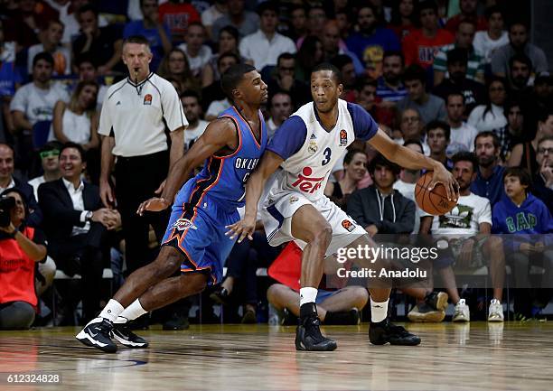 Ronnie Price of the Oklahoma City Thunder is in action against Anthony Randolph of Real Madrid during the basketball match between Oklahoma City...