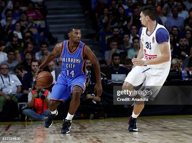 Ronnie Price of the Oklahoma City Thunder is in action against Alex Suarez of Real Madrid during the basketball match between Oklahoma City Thunder...