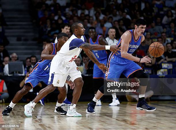 Ersan Ilyasova of the Oklahoma City Thunder is in action against Dontaye Draper of Real Madrid during the basketball match between Oklahoma City...