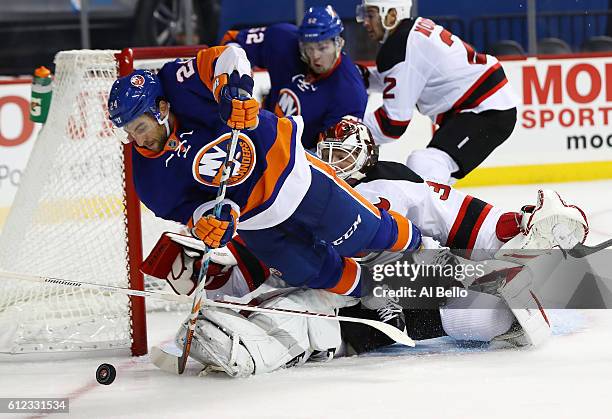 Cory Schneider of the New Jersey Devils makes a save against Stephen Gionta of the New York Islanders during their pre season game at Barclays Center...