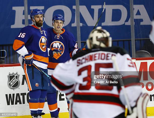 Andrew Ladd of the New York Islanders celebrates his second period goal with Colin Markison against Cory Schneider of the New Jersey Devils during...