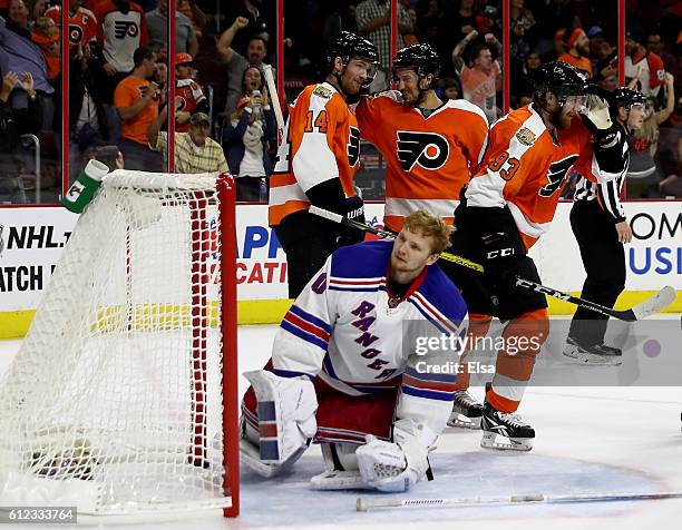 Jakub Voracek of the Philadelphia Flyers is congratulated by teammates Sean Couturier and Michael Del Zotto after Voracek scored the game winning...