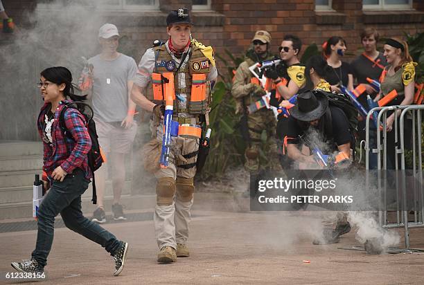 This photo taken on September 17, 2016 shows gamers looking out for "zombies" in "Zedtown", a real-life adventure event based on a video game taking...