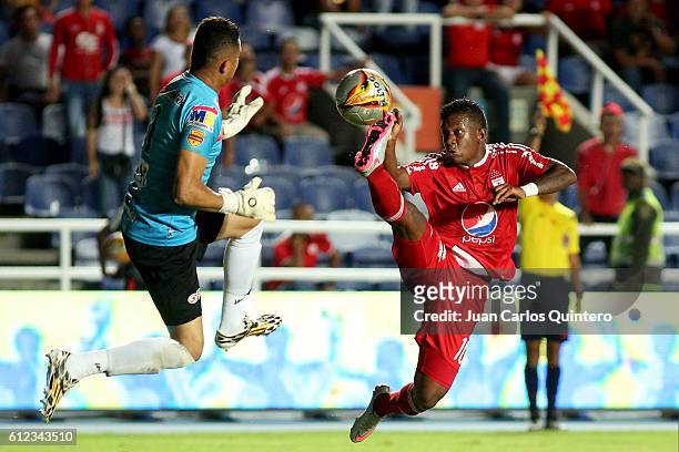 Brayan Angulo of America de Cali and Miguel Torres goalkeeper of Valledupar fight for the ball during a match between America de Cali and Valledupar...