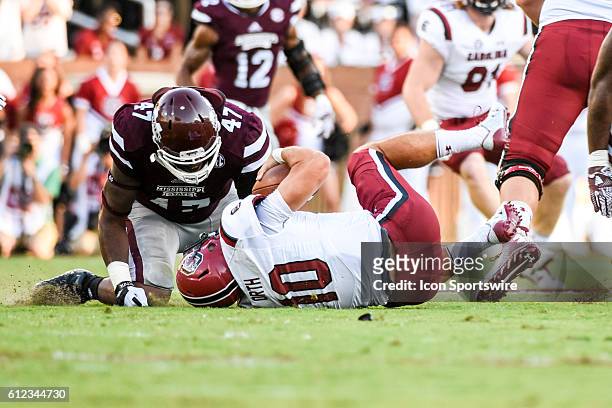 Mississippi State Bulldogs defensive lineman A.J. Jefferson kneels over South Carolina Gamecocks quarterback Perry Orth after a sack during the...