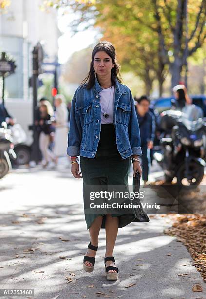 Natasha Goldenberg wearing a denim jacket and green skirt outside Giambattista Valli on October 3, 2016 in Paris, France.