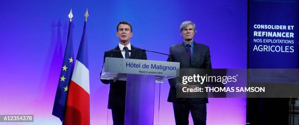 French Prime Minister Manuel Valls speaks about the Support Plan for Agriculture as French Agricultural Minister Stephane Le Foll listens on, at the...