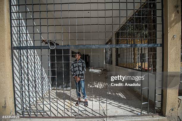 Boy is seen at the Ahmet Selim Mulla high school, that was previously used as a jail and torture rooms by Daesh militants, in Jarabulus, Syria on...