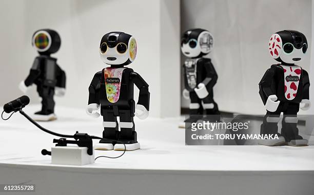 This photo taken on October 3, 2016 shows robot-shaped smartphones called "RoBoHoN", developed by Sharp, on display at a press preview of the...